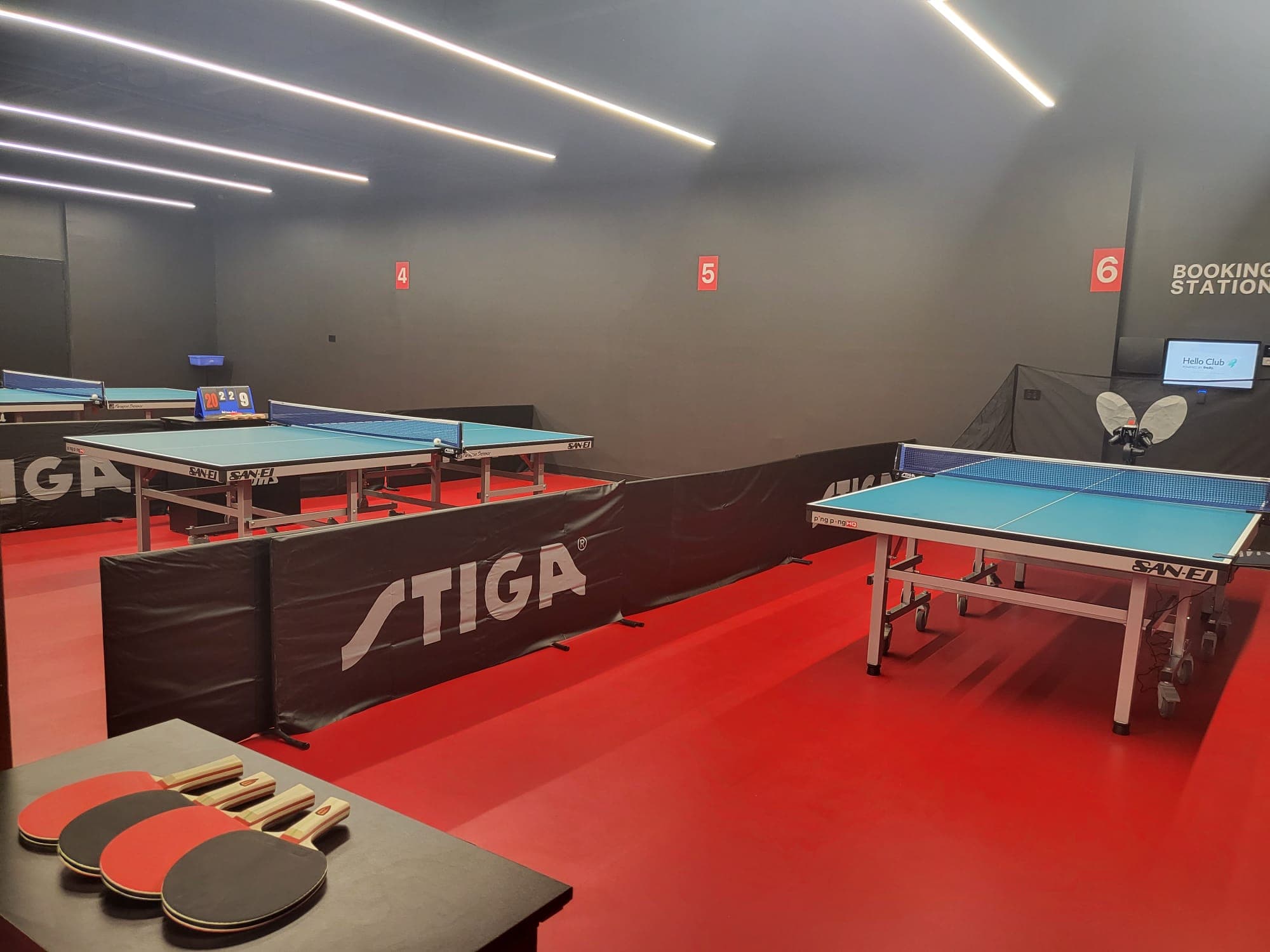 STIGA tables on red flooring inside PingPong HQ